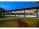Illuminated horse arena surrounded by lush greenery at dusk at 10930 Spring St, Largo, FL 33774