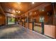 Spacious horse barn featuring brick flooring, wooden walls, and multiple stalls with fans and lighting at 10930 Spring St, Largo, FL 33774