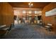 Horse barn featuring brick flooring, wooden walls, and multiple stalls with chairs at 10930 Spring St, Largo, FL 33774