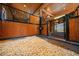 Close-up of an individual horse stall with fresh bedding and wooden walls for comfort at 10930 Spring St, Largo, FL 33774