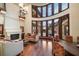 An elegant living room with a fireplace, hardwood floors, and curved windows offering scenic views at 10930 Spring St, Largo, FL 33774