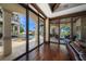 Stunning living room showcasing an outdoor pool, patio with kitchen, and seamless glass doors leading to outdoor spaces at 10930 Spring St, Largo, FL 33774