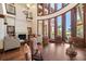 Bright living room features a fireplace, high ceilings, and grand windows with backyard pool views at 10930 Spring St, Largo, FL 33774