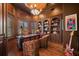 Sophisticated home office with dark wood accents, custom bookshelves, a leather desk, and a chandelier at 10930 Spring St, Largo, FL 33774