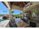 Enjoy outdoor cooking in this outdoor kitchen with stone accents, a grill, a granite countertop bar, and seating at 10930 Spring St, Largo, FL 33774