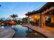 Outdoor living area with custom pool, waterfall, fire bowls, and an outdoor kitchen at 10930 Spring St, Largo, FL 33774