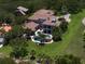 Aerial view featuring a beautiful backyard pool, lush landscaping, and spacious outdoor living areas at 10930 Spring St, Largo, FL 33774