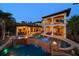 Elegant pool area featuring a spa, fire bowls, and an outdoor kitchen perfect for entertaining at 10930 Spring St, Largo, FL 33774