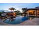 Custom pool with a slide, waterfall, and an outdoor kitchen, ideal for outdoor living at 10930 Spring St, Largo, FL 33774