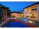 Elegant pool area featuring a spa, fire bowls, and an outdoor kitchen perfect for entertaining at 10930 Spring St, Largo, FL 33774