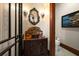 Stylish powder room featuring an ornate mirror, sconces, and a custom vanity at 10930 Spring St, Largo, FL 33774