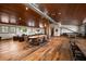 Spacious recreation room with hardwood floors, table, and seating areas, perfect for entertainment at 10930 Spring St, Largo, FL 33774