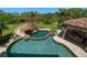 Enjoy this backyard with a custom pool, hot tub, water slide, and an outdoor kitchen, perfect for entertaining guests at 10930 Spring St, Largo, FL 33774