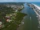Aerial view showcasing the home's waterfront location and lush surroundings at 10930 Spring St, Largo, FL 33774