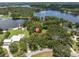 Aerial view of the property showing the home, lake access, pool, and lush surrounding landscape at 11008 Nest Ct, Odessa, FL 33556