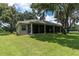 Large home with a screened-in porch and a sprawling backyard with mature trees and lush grass at 11008 Nest Ct, Odessa, FL 33556