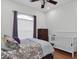Cozy bedroom with wooden floors and a wooden frame bed, next to a white crib at 11008 Nest Ct, Odessa, FL 33556