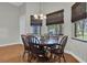 Dining room with wooden table, seating for six, and windows offering outdoor views at 11008 Nest Ct, Odessa, FL 33556