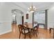 Dining area with hardwood floors, decorative lighting, and an open view to other rooms at 11008 Nest Ct, Odessa, FL 33556