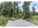 Private dock on the lake, complete with a bench, perfect for relaxing and enjoying waterfront views at 11008 Nest Ct, Odessa, FL 33556