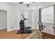 Bright exercise room with wood floors, ceiling fan, natural light, and Bowflex Max Trainer machine at 11008 Nest Ct, Odessa, FL 33556