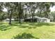 Lovely home with a screened-in porch, set on a large lot with mature trees and lush landscaping at 11008 Nest Ct, Odessa, FL 33556