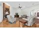 Open living space with a brick fireplace, plush seating, and expansive windows for natural light at 11008 Nest Ct, Odessa, FL 33556