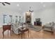 Bright living room featuring hardwood floors, a cozy brick fireplace, and natural lighting at 11008 Nest Ct, Odessa, FL 33556