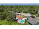 An aerial view of a home and lot, with a pool, landscaping, and a view of the neighborhood at 11362 Heritage Way, Largo, FL 33778