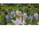 A neighborhood featuring mature trees, well-manicured lawns, private pools, and charming homes at 11362 Heritage Way, Largo, FL 33778