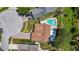 Aerial view showing the home's backyard with pool, patio, landscaping, and surrounding neighborhood at 11362 Heritage Way, Largo, FL 33778