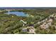 A lush, green neighborhood with houses backing onto a beautiful lake, offering serene waterfront living at 11362 Heritage Way, Largo, FL 33778