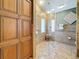 Spacious bathroom featuring glass shower, tiled walls, and granite counters at 11362 Heritage Way, Largo, FL 33778