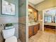 Bathroom showcasing custom tile, granite counters, decor, and bedroom access at 11362 Heritage Way, Largo, FL 33778