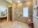 Bright bathroom featuring a glass shower, linen closet and tiled walls at 11362 Heritage Way, Largo, FL 33778