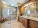 Elegant bathroom featuring decorative tile work, granite counters, and glass shower at 11362 Heritage Way, Largo, FL 33778