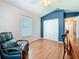 Inviting bedroom featuring hardwood floors, white closet doors, and soft, natural light at 11362 Heritage Way, Largo, FL 33778