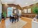 Elegant dining area with hardwood floors, chandelier lighting, and decorative wall art accents at 11362 Heritage Way, Largo, FL 33778