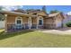 Inviting front porch with stone accents and quaint seating offering a welcoming entry to the residence at 11362 Heritage Way, Largo, FL 33778