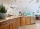 Bright, open kitchen featuring granite countertops, stainless steel appliances, and wood cabinetry at 11362 Heritage Way, Largo, FL 33778