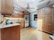 Well-equipped kitchen with wooden cabinets, granite countertops, and stainless steel refrigerator at 11362 Heritage Way, Largo, FL 33778