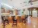 Spacious kitchen island with bar stool seating, granite countertops, and wood cabinets at 11362 Heritage Way, Largo, FL 33778
