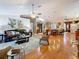 Open-concept living room with hardwood flooring, comfortable seating, and kitchen access at 11362 Heritage Way, Largo, FL 33778