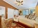 Bedroom with hardwood floors, ceiling fan, decor, and screened porch access at 11362 Heritage Way, Largo, FL 33778