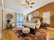 Bedroom showcasing hardwood floors, ceiling fan, rug, decor and screened porch access at 11362 Heritage Way, Largo, FL 33778