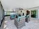 Inviting screened patio with comfortable seating and ceiling fans at 11362 Heritage Way, Largo, FL 33778
