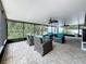 Inviting screened patio with comfortable seating and ceiling fans at 11362 Heritage Way, Largo, FL 33778