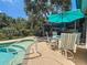 Backyard pool and outdoor patio with comfortable seating and shade at 11362 Heritage Way, Largo, FL 33778