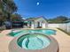 Backyard with a sparkling pool, spa, and screened patio at 11362 Heritage Way, Largo, FL 33778