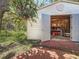 Shed with open door, shelves, and tools, on a brick base with green yard at 11362 Heritage Way, Largo, FL 33778